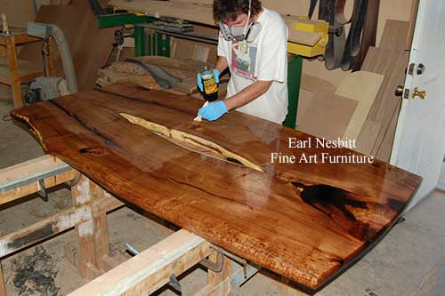 Earl oiling this live edge dining table